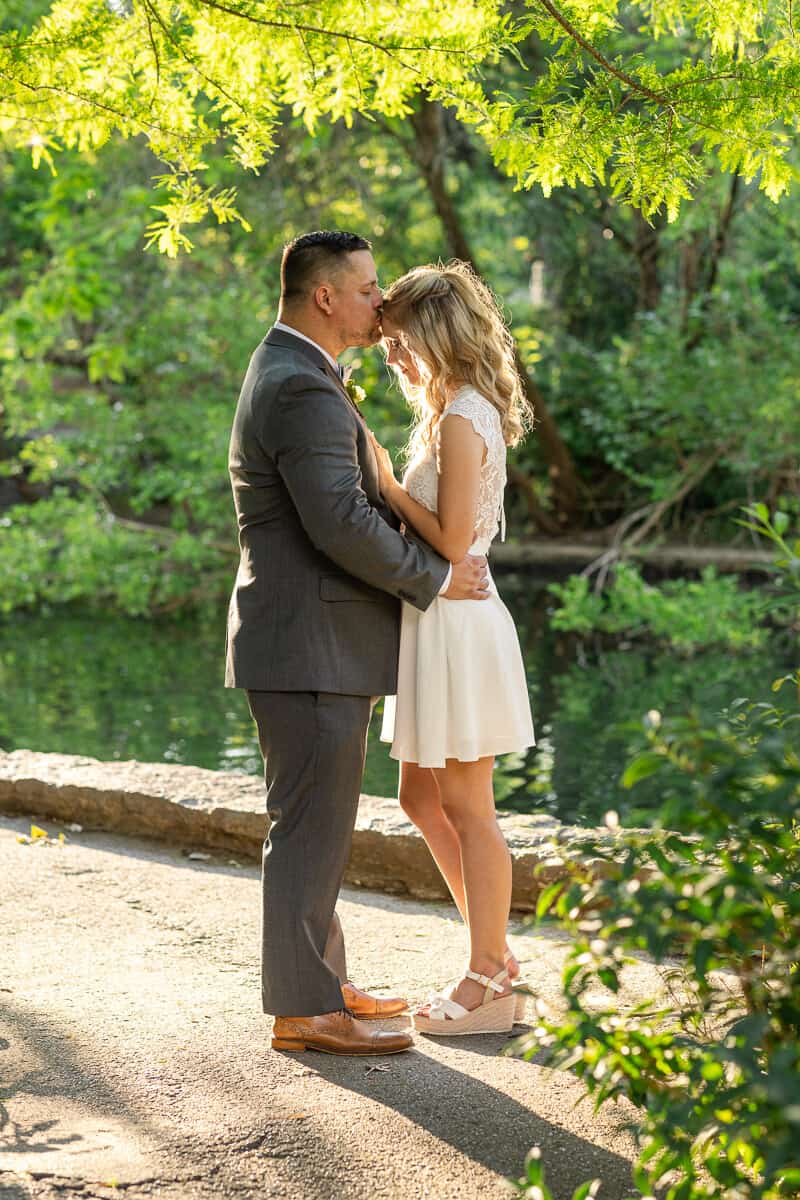 Bride and groom touch foreheads in sunset glow